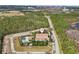 Aerial view of the apartment complex in a heavily wooded area with a nearby community pool at 14530 Damai Ln, Orlando, FL 32821