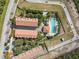 An aerial view showing buildings surrounded by trees and vegetation with a pool and plenty of room to relax at 14530 Damai Ln, Orlando, FL 32821