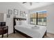 Well-lit bedroom with a queen-sized bed, stylish artwork, and a large window offering ample natural light at 14530 Damai Ln, Orlando, FL 32821