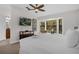 Bedroom showcasing neutral colors, a large window, and a ceiling fan for added comfort at 14530 Damai Ln, Orlando, FL 32821