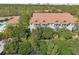 Aerial shot of a multi-Gathering home boasting a terra cotta roof and lush greenery at 14530 Damai Ln, Orlando, FL 32821