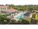 A community pool with lush green grounds and a covered barbecue and kitchen area at 14530 Damai Ln, Orlando, FL 32821