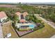 Aerial view of a stunning community pool with plenty of seating, loungers, and shaded areas at 14530 Damai Ln, Orlando, FL 32821