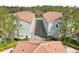 An overhead rooftop view of a well-maintained apartment building with nearby shrubbery and vegetation at 14530 Damai Ln, Orlando, FL 32821