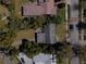 Aerial view of a house and its surrounding trees, driveway, and the nearby street at 1531 Norfolk Ave, Winter Park, FL 32789