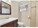 Bathroom with a vanity, toilet, mirror and window at 1531 Norfolk Ave, Winter Park, FL 32789