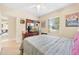 Bright bedroom with ceiling fan, flat-screen television, and natural light at 1531 Norfolk Ave, Winter Park, FL 32789