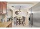 Kitchen dining area featuring granite countertops, a glass table, and stainless steel refrigerator at 1531 Norfolk Ave, Winter Park, FL 32789