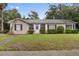 Charming single-story home with manicured lawn, black shutters, and a welcoming entrance at 1531 Norfolk Ave, Winter Park, FL 32789