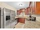 Kitchen with stainless steel appliances, granite countertops, and dark wood cabinets at 1531 Norfolk Ave, Winter Park, FL 32789