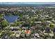 Aerial view of a neighborhood with lush trees and a scenic lake nearby at 1627 Triangle Ave, Orlando, FL 32806