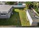 Aerial view of a home and backyard with a detached shed and privacy fence at 1627 Triangle Ave, Orlando, FL 32806