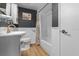 Classic bathroom with white subway tile in shower, white vanity and contrasting black walls at 1627 Triangle Ave, Orlando, FL 32806