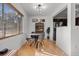 Bright dining area featuring a modern table set, hardwood floors, and natural light at 1627 Triangle Ave, Orlando, FL 32806