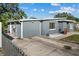 This home showcases a gray painted exterior and a well-maintained lawn at 1627 Triangle Ave, Orlando, FL 32806