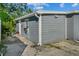 This home's exterior features painted siding, white trim, a paved walkway, and well-maintained landscaping at 1627 Triangle Ave, Orlando, FL 32806