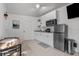 This bright kitchen features neutral walls, modern appliances, tile floors, and plenty of storage space at 1627 Triangle Ave, Orlando, FL 32806