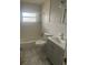 Bathroom featuring tile walls, marble floors, gray vanity, a toilet, and a tub at 1907 Rockwell Rd, Orlando, FL 32808