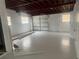 Spacious garage features exposed ceiling and freshly painted floor at 1907 Rockwell Rd, Orlando, FL 32808