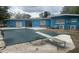 Backyard pool with diving board, covered for the season, next to the blue house at 1907 Rockwell Rd, Orlando, FL 32808