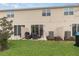 Exterior view of a patio area in a backyard, with a lawn and mature tree at 2029 Crystal Bell St, Orlando, FL 32824