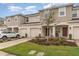 Attractive townhome showcasing a neatly landscaped yard and covered entryway at 2029 Crystal Bell St, Orlando, FL 32824