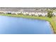 Rear view of townhomes overlooking a serene pond and green lawn at 2029 Crystal Bell St, Orlando, FL 32824