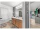 Neutral-toned bathroom featuring a vanity, a commode, and a view into an adjacent bedroom at 2234 Rockwood Dr, Apopka, FL 32703