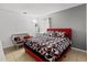 Cozy bedroom featuring a red bed frame, patterned bedding, and a comfortable seating area at 2234 Rockwood Dr, Apopka, FL 32703