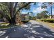 Community entrance gate with mature trees, lush landscaping and guard house at 2734 Cattail Ct, Longwood, FL 32779