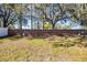 Backyard has a brick wall barrier and old trees offering a rustic backdrop and privacy at 2978 Stillwater Dr, Kissimmee, FL 34743