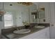 Bathroom featuring a double sink vanity with granite countertop and a large mirror at 2989 Viscount Cir, Kissimmee, FL 34747