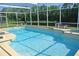 View of the screen-enclosed pool in yard at 2989 Viscount Cir, Kissimmee, FL 34747