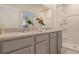 Bathroom featuring double sinks, granite countertop, large mirror, and walk-in shower at 2997 Moulin Rd, Davenport, FL 33837