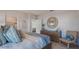 Cozy bedroom featuring a king bed with decorative pillows, a wicker chair and a wood dresser at 3001 Moulin Rd, Davenport, FL 33837