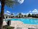 Resort-style community pool surrounded by lounge chairs and palm trees, offering a relaxing outdoor experience at 316 South Zuni Rd, St Cloud, FL 34771