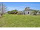 Expansive backyard featuring a screened-in porch and lush green lawn at 3455 Bellingham Dr, Orlando, FL 32825