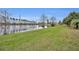 This yard is a lakefront property with a lush green lawn that slopes down to the water's edge at 3455 Bellingham Dr, Orlando, FL 32825