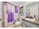 Cozy bathroom showcasing a lavender theme with a decorative shower curtain and vanity area at 3455 Bellingham Dr, Orlando, FL 32825