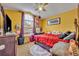 This bright bedroom features a large window, a ceiling fan and vibrant wall paint at 3455 Bellingham Dr, Orlando, FL 32825