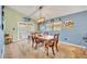 Cozy dining area with a wooden table set, a stylish chandelier, and lots of natural light at 3455 Bellingham Dr, Orlando, FL 32825