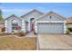 Charming single-story home showcasing a well-manicured lawn and a spacious two-car garage at 3455 Bellingham Dr, Orlando, FL 32825