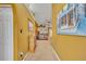 Interior hallway featuring neutral carpeting and decorative wall art leading to the living room at 3455 Bellingham Dr, Orlando, FL 32825