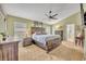 Spacious main bedroom with a large bed, ample natural light, and tasteful decor at 3455 Bellingham Dr, Orlando, FL 32825