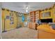 Home office featuring warm wall color, ceiling fan, built-in bookshelves, and a baseball theme at 3455 Bellingham Dr, Orlando, FL 32825