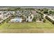 An aerial shot features a community pool and playground with green space amid a residential neighborhood at 4115 Ruby Run, Haines City, FL 33844
