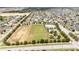 Aerial view of neighborhood amenities: community pool, playground, and green spaces for recreation at 4115 Ruby Run, Haines City, FL 33844