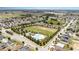 Aerial view of the community pool, playground, and surrounding homes and landscaping at 4115 Ruby Run, Haines City, FL 33844