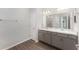 Bathroom with double sinks, granite counters, and a glass-door shower at 4115 Ruby Run, Haines City, FL 33844