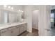 Bright bathroom boasts double sinks, grey cabinetry, and a separate water closet for added privacy and convenience at 4115 Ruby Run, Haines City, FL 33844